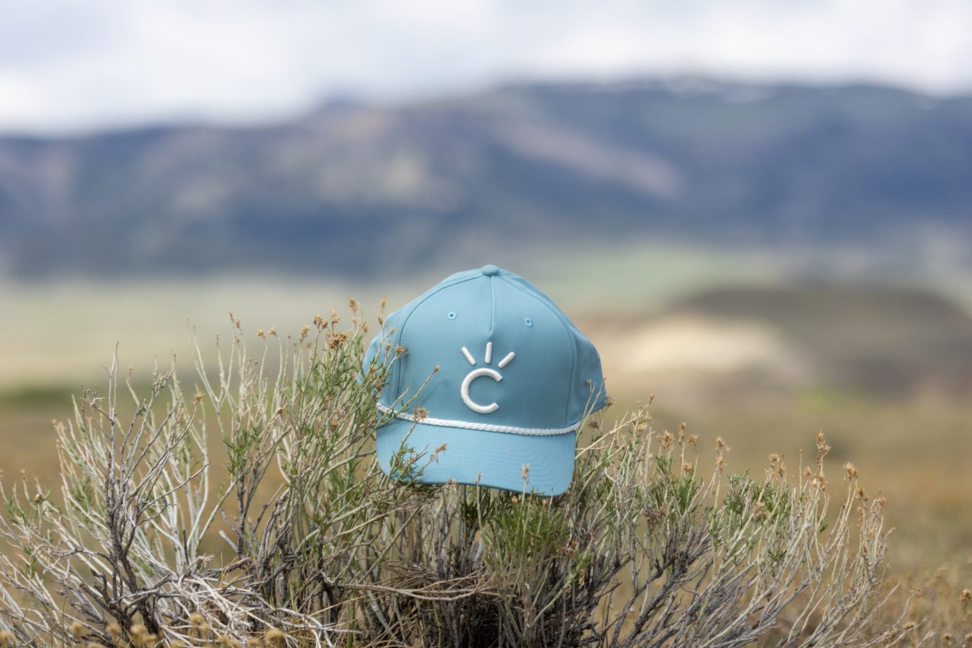 The Big Sky Cap, a light blue Cavvy rope hat, photographed outside in sagebrush